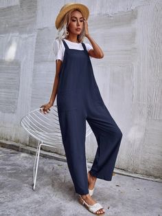 This Dual Pocket Sleeveless Jumpsuit is the perfect combination of comfort and style. Crafted from a lightweight fabric blend with a slight stretch, this jumpsuit offers you optimal breathability and flexibility. The stylish letter pattern gives it an edgy look, while the dual pocket design adds practicality to your everyday outfit. It also features a collared neckline, short sleeves, and a short length that provides coverage without sacrificing fashion. This jumpsuit is sure to keep you comfortable all day long in any season! Features: Color: Navy Blue Style: Casual Pattern Type: Plain Type: Overall Details: Button, Pocket Length: Long Fit Type: Regular Fit Neckline: Straps Sleeve Length: Sleeveless Waist Line: Natural Fabric: Non-Stretch Material: Fabric Body: Unlined Sheer: No Size Char Solid Color Relaxed Fit Jumpsuit For Leisure, Versatile Jumpsuits And Rompers With Pockets For Loungewear, Comfortable Solid Jumpsuits And Rompers With Pockets, Comfortable Leisure Overalls And Rompers, Comfortable Cotton Jumpsuits With Side Pockets, Comfortable Jumpsuits And Rompers With Pockets, Comfortable Relaxed Fit Overalls, Comfortable Cotton Jumpsuits And Rompers With Pockets, Sleeveless Jumpsuits And Rompers With Side Pockets For Loungewear