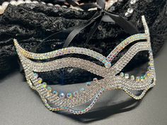 Step into the realm of mystery and elegance with our exquisite masquerade mask, adorned with high-quality crystals that glimmer and shine with every movement. Designed to capture the essence of classic masquerade allure, this mask is a masterpiece of craftsmanship, perfect for making a grand entrance at any gala, ball, or festive event. Its intricate pattern and sparkling details add a dash of glamour, transforming your presence into the highlight of the night. Whether celebrating a birthday, at Elegant Crystal Headpiece For Party, Elegant Masks For Mardi Gras Party, Elegant Eye Mask For Party, Adjustable Rhinestone Headpiece For Party, Elegant Carnival Party Masks, Adjustable Party Headpiece With Rhinestones, Glamorous Silver Headpieces For Party, Rhinestone Eye Masquerade Mask For Costume Party, Rhinestone Eye Mask For Masquerade Costume Party