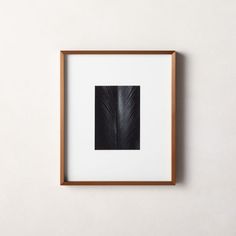 a black and white photograph hanging on a wall next to a wooden framed art piece