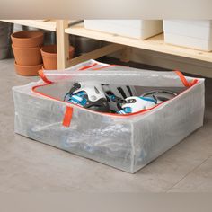 a plastic bag filled with lots of different types of items on top of a table