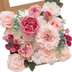 a bouquet of pink and white flowers in a cardboard box