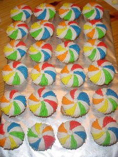 cupcakes decorated with multicolored icing on a tray