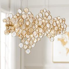 a chandelier with lots of coins hanging from it's sides in a room