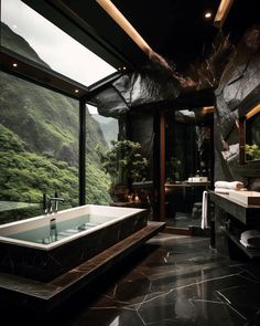 a bathroom with a large bathtub next to a window and a mountain view in the background