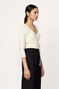 Introducing our latest elevated essential, the Ballet Wrap Top, designed for comfort and style. Crafted from lightweight raw silk jersey, this tee boasts a flattering v-neck and chic long sleeves. For an easy look pair it with our Boyfriend Trouser or Tailored Skirt. Made with 100% raw silk.Machine wash cold, lay flat to dry.Handmade in India. Honoring Earth + Maker Our jersey knitwear is handcrafted in India, preserving age-old Indian textile traditions. They are made in beautiful, family-opera Boyfriend Trousers, Ballet Wrap Top, Silk Noil, Tailored Skirt, The Ballet, Indian Textiles, Ivory Silk, Beautiful Family, Wrap Top