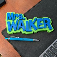 a pen sitting on top of a desk next to a laptop