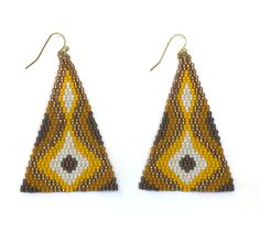 two triangle shaped beaded earrings with yellow and white designs on the front, one in gold