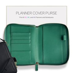 an open green leather case with zippers on the front and inside, sitting next to a black purse