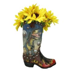 a boot with yellow flowers in it sitting on top of a white floor next to a vase