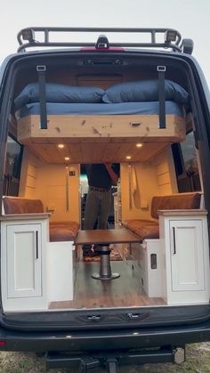 the back end of a van with its bed in it's trunk and storage compartment