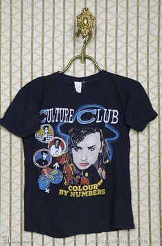 a t - shirt hanging on a wall with the words culture club printed on it