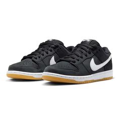 NIKE SB DUNK LOW PRO BLACK GUM The sneakers' nubuck uppers are almost entirely black with white accents embroidered onto the lateral and medial sides of the Swoosh logo from Nike. All of this rests on top of a thick white midsole that is covered in full-length cushioning to make sure that these are more than up to the task of handling the high-impact sport of skateboarding. A gum sole gives the outfit a polished finish. Harrods London, Cushions To Make, Nike Force