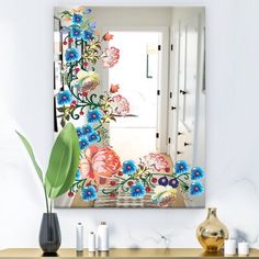 a mirror sitting on top of a wooden dresser next to a vase filled with flowers