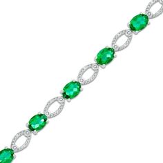 So luxe and lovely, she'll turn to this eye-catching fashion bracelet for every special occasion. Crafted in sterling silver, this engaging design features 7.0 x 5.0mm oval-shaped lab-created bright green emeralds alternating with diamond-accented open oval-shaped links. A look that proclaims her sophisticated style, this 7.5-inch bracelet is buffed to a brilliant luster and secures with a durable lobster claw clasp. Fine Jewelry Sterling Silver Oval Bracelet, Oval Sterling Silver Bracelet In Fine Jewelry Style, Elegant Green Oval Diamond Bracelet, Classic Sterling Silver Bracelet With Oval Gemstone, Classic Sterling Silver Oval Gemstone Bracelet, Classic Oval Gemstone Sterling Silver Bracelet, Oval Diamond Bracelet For Formal Occasions, Elegant Sterling Silver Bracelet With Oval Gemstone, Elegant Sterling Silver Oval Gemstone Bracelet