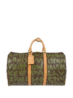 circa 2001 coffee brown/light brown/green canvas signature Monogram canvas signature Graffiti print Vachetta leather trim leather tag two rolled top handles two-way zip fastening internal jetted pocket full lining gold-tone hardware rectangle body Condition: GOOD. This previously owned and used item is in good condition with minimal signs of use. This may include fading of material or plating and scratches. Purchasing this item continues its narrative and reduces the environmental impact by avoiding the use of new resources needed to make the product from scratch, such as water, materials and electricity, and avoiding additional manufacturing impact. Learn more about what makes a product Conscious on our Conscious Criteria page Brown Monogram Canvas Duffle Bag, Designer Monogram Canvas Duffle Bag, Designer Brown Coated Canvas Travel Bag, Brown Designer Coated Canvas Travel Bag, Brown Coated Canvas Travel Bag With Handles, Brown Monogram Canvas Travel Bag With Luggage Sleeve, Brown Monogram Canvas Travel Bag, Travel Duffle Bag With Leather Handles And Monogram Canvas, Pre-owned Monogram Canvas Travel Bag