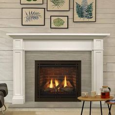 a living room with a fire place and pictures on the wall