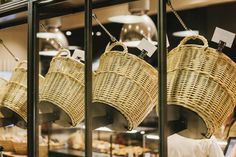 some baskets hanging from hooks in a store