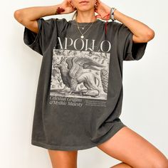 Get ready to be OBSESSED with your new Greek Mythology shirt. It's the cutest and most trendy way to combine all those important trendy mythology aesthetic vibes! This is the perfect shirt for you!  * Q U I C K * F A C T S * ✺  All shirts are UNISEX ✺  100%  ringspun cotton (fiber content may vary for different colors) ✺  Soft-washed, garment-dyed fabric brings extra coziness ✺  Wash and dry normally (on cool for best results) ✺  Sewn-in twill label * S I Z I N G * ✺ For an oversized fit, select two or three sizes up from your normal size ✺ Model is wearing size L  ✺ Sizing runs true to size ✺ Relaxed fit ✺ Most women find their typical size works best, since they are meant to fit a touch loose ✺ See Size guide and fit in images          * S H I P P I N G * T I M E S * ✺ Our items are indi Mythology Aesthetic, Apollo Greek, Cottage Core Shirt, Bookish Merch, Greek Apparel, Greek Clothing, Aesthetic Vibes, Light Academia, Art T Shirt