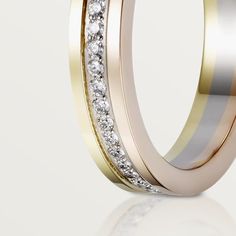 two tone gold and silver wedding rings with diamonds on each side, set against a white background