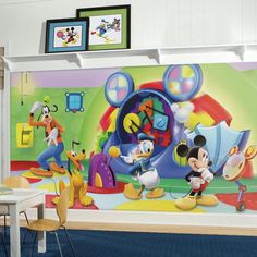 mickey mouse wall mural in a child's room with other children's artwork