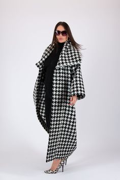 Women Houndstooth Coat, Wool Winter Coat, Long Cape Coat Black and white Coat-Vest with two side pockets, loose fit,  long sleeves and big collar.  * The coat don't have a lining and buttons.  SIZE & FIT: *Our Model is 5′6″ / 175 cm and wears size M. *Available Sizes: form XS up to 8XL *This product could be customized according to your measurements. *Please leave your requirements in the checkout. CARE Dry Cleaning  Machine Wash 30oC Hand Wash with warm water Medium hot iron Time to ship & DELIVERY : Your piece will be ready to ship in 5-6 biz days upon placing your order. UPS Express Worldwide - 3-4 days delivery time Explore the rest of my collection here: https://www.etsy.com/shop/EUGfashion  For any Personal questions and Business queries, please do not hesitate to contact us. Thank y Mantel Cape, Long Cape Coat, Coat Cape, Black And White Coat, Long Cape, Houndstooth Coat, Wool Winter Coat, Big Collar, Wool Overcoat