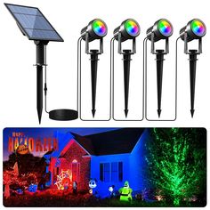 four solar powered garden lights in front of a house with trees and christmas decorations on the lawn