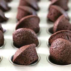 chocolate cupcakes are lined up in muffin tins