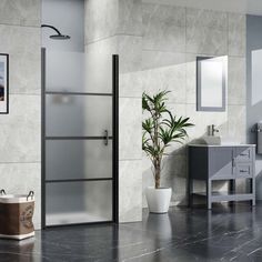 a bathroom with marble walls and flooring next to a potted plant on the counter