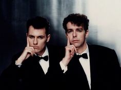 two men in tuxedos are posing for the camera with their hands on their chins