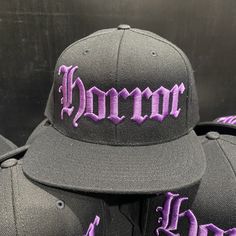 "HORROR HAT Black Snapback Hat Purple Embroidery On Black Hat BLACK Under-Bill 80% Acrylic / 20% Wool Suggested Size Range: Fits hat sizes: 7 - 7 3/4 (22\"-24.25\")" Purple Baseball Cap For Streetwear, Purple Curved Brim Baseball Cap For Streetwear, Purple Curved Brim Hat For Streetwear, Purple Snapback Baseball Cap, Purple Snapback Cap For Streetwear, Purple Snapback Hat For Streetwear, Purple Snapback Trucker Hat, Embroidered Black Snapback Hat With Flat Brim, Embroidered Flat Brim Fitted Hat For Streetwear