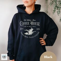 Are you ready for the Halloween and Spooky Season?    This cozy and soft hoodie features the Witches Brew Coffee House from Salem Massachusetts on the front of the hooded sweatshirt.   This sweater is perfect for Fall walks, Halloween parties or to get you ready for the Fall, Spooky and Halloween Season.   The design features a trendy, vintage and faded design.   Our store personally created this design.  It's also available in mugs, pillows, sweatshirts, t-shirts and on the back of a hoodie. Black Fleece Halloween Hoodie, Black Fleece Hoodie For Halloween, Winter Black Pre-shrunk Hoodie, Pre-shrunk Black Hoodie For Winter, Black Pre-shrunk Hoodie For Winter, Halloween Fleece Hoodie, Halloween Cotton Sweatshirt With Drawstring Hood, Halloween Cotton Hoodie Sweatshirt, Black Halloween Top With Drawstring Hood