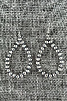 These sterling silver bead earrings were made by Navajo silversmith Louise Joe.Length: 2 5/8"Width: 1 1/4"Bead Size: 3/16"Free shipping on all orders! We ship with USPS and always include tracking. All orders ship within a day of payment.Returns are accepted up to 30 days after you receive your order. Just send us a message. Our shop offers cash back or store credit. The item must be returned in new condition. Silver Dangle Jewelry With Polished Beads, Sterling Silver Earrings With Polished Beads, Southwestern Style Silver Beaded Dangle Jewelry, Southwestern Style Silver Jewelry With Polished Beads, Southwestern Sterling Silver Beaded Jewelry, Sterling Silver Dangle Jewelry With Polished Beads, Artisan Silver Earrings With Round Beads, Southwestern Sterling Silver Hand-strung Jewelry, Silver Drop Earrings With Silver Beads