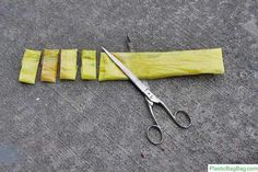 a pair of scissors sitting on top of a piece of yellow cloth next to it