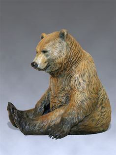 a statue of a bear sitting on the ground