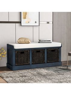 a blue storage bench with wicker baskets on top and a white rug in front