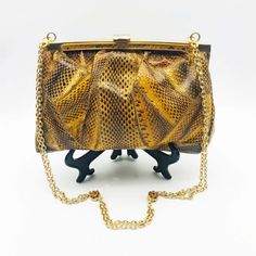 "Vintage Python Handbag Purse Circa 1970s Patchwork Snakeskin Leather Shoulder Bag Gold Tone Metal Frame & Secure Clasp Gold Metal Chain Link Shoulder Strap with amber Rhinestone Stations Suede Lining Inner Zip Up Pocket Exotic Late 20th Century Fashion Accessory In good vintage condition NB: There is minor fading of the gold gilt on the metal frame. Moderate indications of age & use internally Jewelled Stations missing one or two rhinestones bag approx: 9\" (22.5cm) wide x 6\" (15.5cm) tall  Ch Vintage Brown Evening Bag For Party, Vintage Gold Shoulder Bag With Chain Strap, Retro Brown Clutch For Evening, Brown Party Clutch With Chain Strap, Vintage Brown Bag With Chain Strap, Retro Evening Bag With Chain Strap, Retro Evening Bags With Chain Strap, Retro Brown Bags For Party, Retro Brown Bag For Party