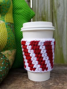 a coffee cup holder made out of crochet and knitted yarn with a red white and blue stripe