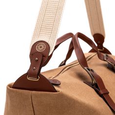 Safari-style light and resistant canvas travel bag.   Zip closure.  Adjustable buckle straps.   Removable and adjustable strap.   Internal pockets.   Material: canvas and vegetable tanned leather.   Available to customize.  Size: Base width 26 cm x Width 65 cm x Height 30 cm x Depth 20 cm.   Light and resistant travel bag made of canvas and leather. Its surprisingly spacious interior contains internal pockets to keep personal items organized. It is a bag designed to take on a weekend getaway or Beige Travel Bag With Leather Handles For Everyday Use, Brown Travel Luggage With Adjustable Strap, Luxury Travel Duffle Bag With Adjustable Strap, Classic Leather Trim Tote Duffle Bag, Classic Brown Travel Bag With Leather Trim, Classic Weekender Bag With Leather Handles For Travel, Leather Trim Tote Shoulder Bag For Overnight Trips, Brown Satchel Luggage With Adjustable Strap, Classic Luggage With Leather Trim For Daily Use