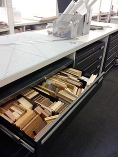 an office desk with drawers full of files