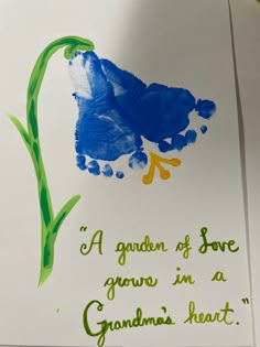 a blue flower with green stems and the words, a garden of love grows in a grandma's heart