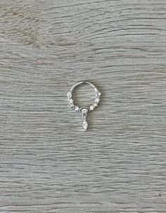 a silver ring sitting on top of a wooden table