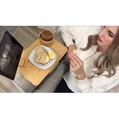 a woman sitting at a table with a plate of food