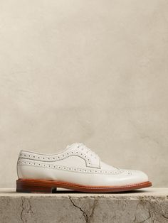 We reimagined the traditional oxford style with its intricate brogue detailing and wingtip silhouette, choosing a beautiful leather in a rich off-white ivory color from Portugal.  Portuguese leather uppers and lining.  Leather and rubber sole.  Blake stitch sole construction.  Made in Portugal.  B width.  Heel height: 0. 5" White Oxford Shoes Outfit, White Oxford Shoes, Oxford Shoes Outfit, Oxford Style, Ivory Color, Leather Sneakers, Chelsea Boots, Banana Republic, Rubber Sole