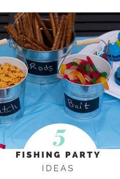 five buckets filled with different types of food on top of a blue table cloth