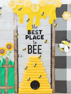 a bee themed bulletin board with bees and honeycombs on the front, next to a sign that says the best place to be