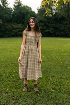 Experience effortless elegance with our Chestnut Dress. This modest dress features a flattering A-line silhouette and a warm plaid print that will carry you through every season. Whether you're attending a social gathering or enjoying a leisurely outing, this dress offers comfort and style in one package. The Chestnut Casual Plaid A-line Dress, Casual Brown Dress For Picnic, Casual A-line Plaid Dress, Casual Plaid Midi Dress For Picnic, Cottagecore Plaid Dress With Short Sleeves, Casual Fall Picnic Dresses, Classic Fitted Plaid Dress For Fall, Fitted Brown Plaid Dress, Fitted Brown Plaid Dress For Spring