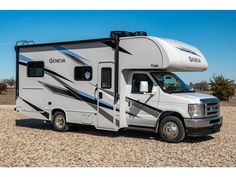 an rv parked on gravel in the desert