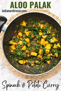 spinach and potato curry in a skillet with text overlay that reads aloo palak