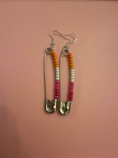 Celebrate Pride with homemade custom earrings! Can be personalized. Be sure to let me know which one(s) you are interested in. Flags include: lesbian, gay/mlm, transgender, bisexual, pansexual, nonbinary, asexual, genderfluid, agender, and aromantic, but will take personalization requests.  Silver and gold clip ons are available upon request. Queer Earrings, Beloved Jewelry, Lesbian Earrings, Gay Rights, Pin Earrings, Safety Pin Earrings, Lesbian Flag, Gold Clips, Custom Earrings