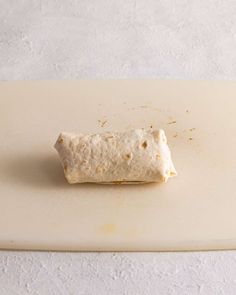 a piece of food that is on top of a cutting board with some dirt on it